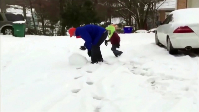 Father throws enormous snow ball and crushes his son