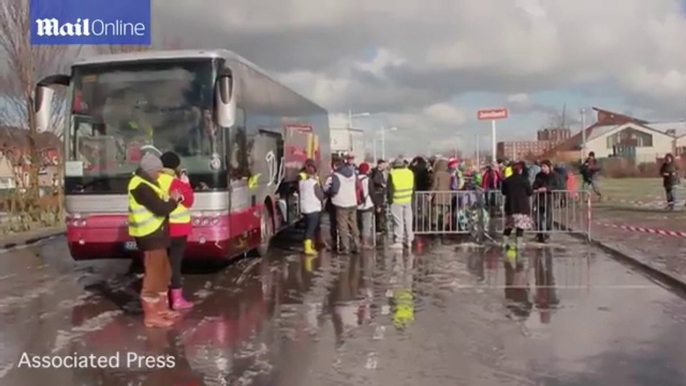 Migrants move from camps to wooden shelters in Grande-Synthe