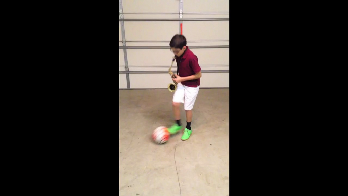 11 year old juggles a soccer ball while playing Pink Panther on Saxophone