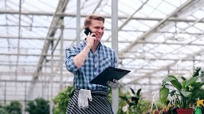 Young Man Talking On The Phone In Greenhouse. - Stock Footage | VideoHive 15091922