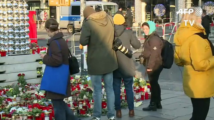 People in Berlin remember victims of market attack