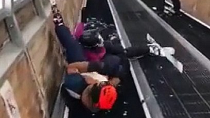 Quand un couple de skieurs se retrouve piégé sur un tapis roulant... FAIL