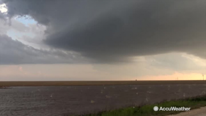 Baseball-sized hail splashes in pond as mothership supercell looms overhead