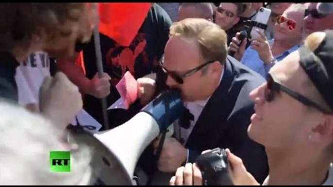 Infowars frontman Alex Jones faces & fights anti-Trump protesters