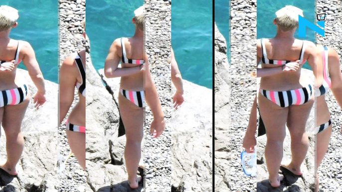 Make-up free Katy Perry puts on a busty display in a bright striped bikini as she takes a daring plunge into the sea during idyllic beach day in Amalfi