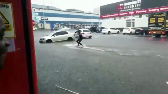 Surfer Takes to Flooded Streets as Storm Hits Durban