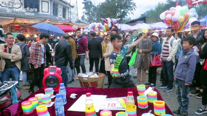 Chinese slinky salesman shows off his mad skills