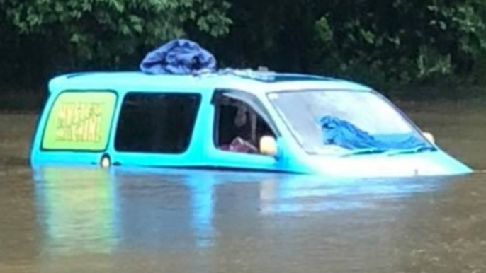 British Backpackers Wake Up to Find Van Partially Submerged by Floodwaters