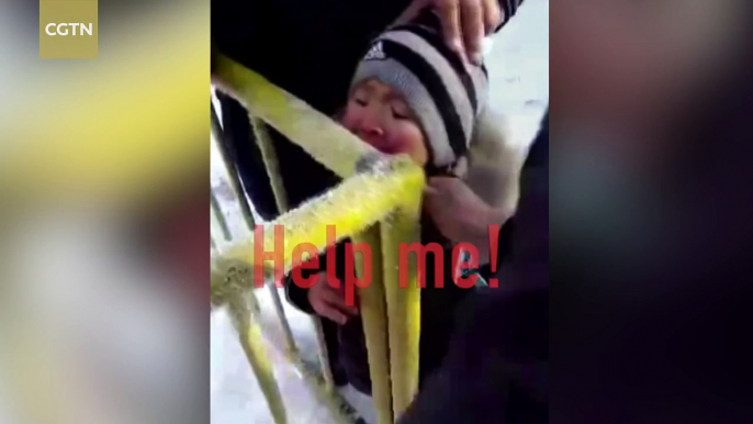 Boy gets his tongue stuck to icy metal pole