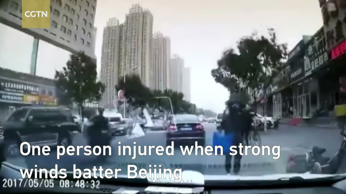 Watch: Rider knocked off his vehicle by a tin roof dislodged by strong wind
