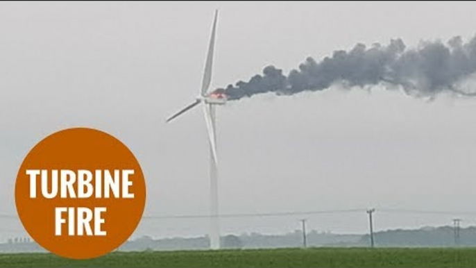 A wind turbine catches fire after thunder and lightening strikes