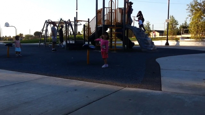 Two and Three Year Old Toddlers / Children Playing with Spinning Chairs at the Park