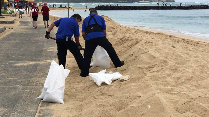 Workers fill up sandbags in Waikiki ahead of Hurricane Lane landfall