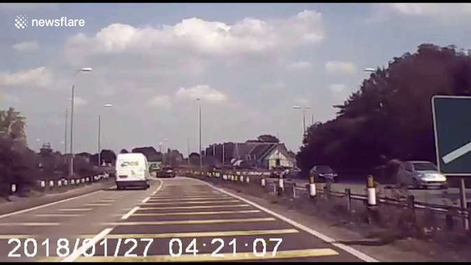 Shocking moment speeding van is filmed flying over roundabout