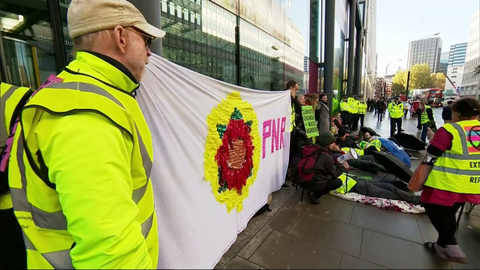 Protesters glue themselves to government building