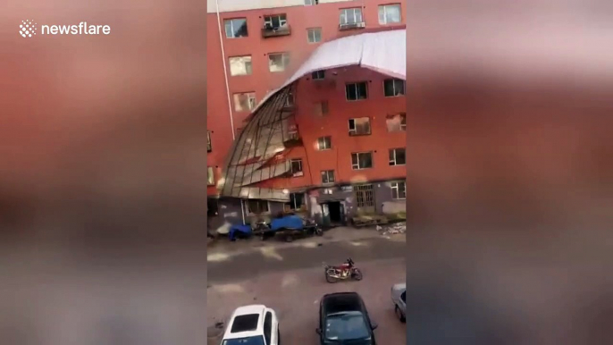 Woman freaks out when strong wind rips roof off building