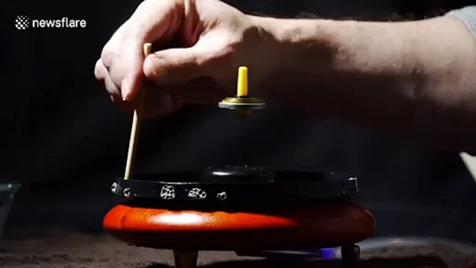 Spinning top levitates inside smoke-filled bubble