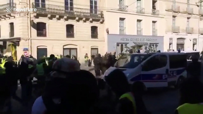 Injured man pulled to safety during yellow vest protests in France