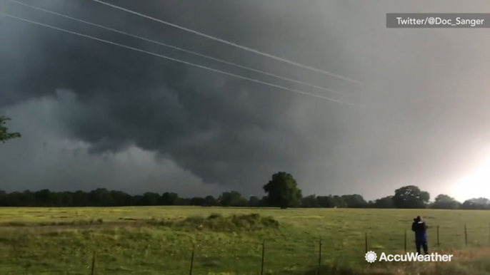 Eerie funnel clouds appear overhead in wake of possible tornado