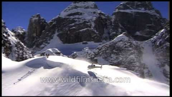 Helicopter drops adventure seeking skiers on Himalayan mountain top!