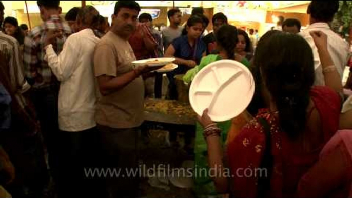 Devotees standing in a queue and waiting for their turn for prashad at Durga Puja