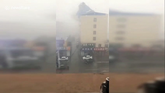 Roof ripped off by strong wind crashes onto parked vehicles below in northern China