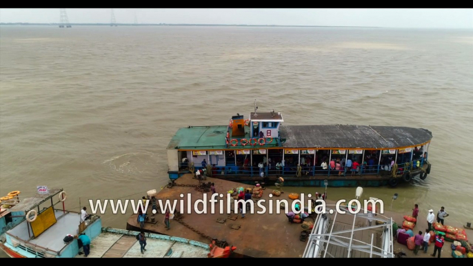 CROSSING THE RIVER HOOGHLY- Kakdwip to Gangasagar local ferry, River Hooghly meeting the Bay Of Bengal, West Bengal, India. 4k Aerial stock Footage.