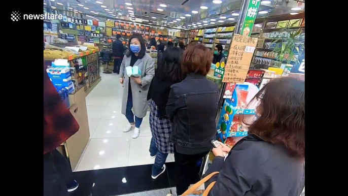 Hong Kong residents queue for protective masks as first death from coronavirus reported in the city