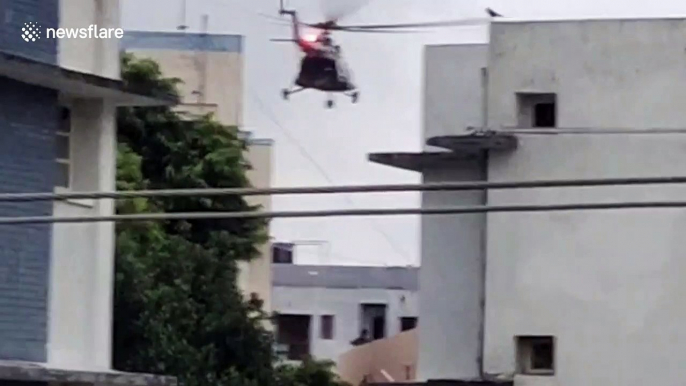 Helicopters drop food packets on rooftop of flood-hit areas in northern India