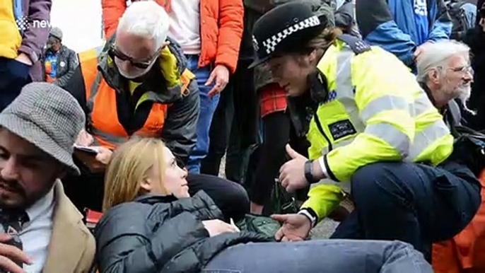 Extinction Rebellion protesters glue themselves to road outside London City Airport