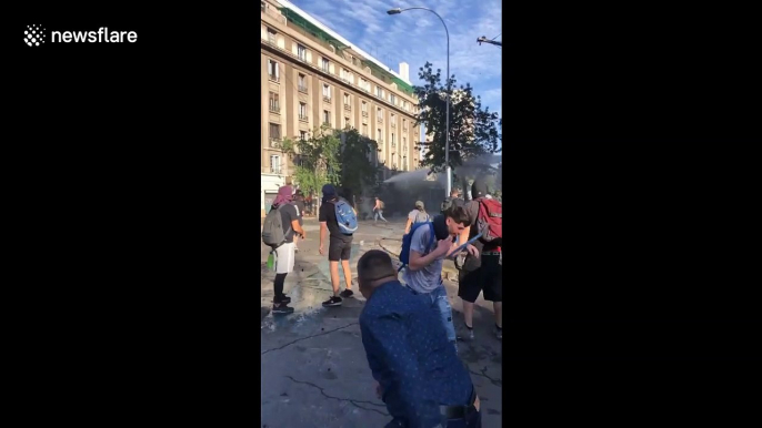 Police fire water cannon as Chilean protesters defy emergency decree