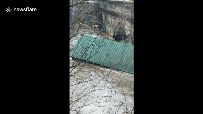 West Yorkshire bridge closed as shipping container carried by Storm Ciara flooding becomes lodged under it