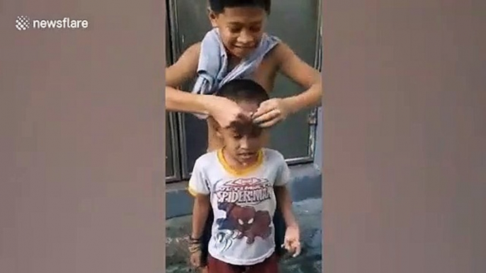 Filipino boys trick their friend with coin game