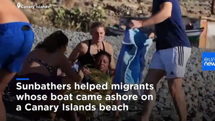 Sunbathers come to aid of exhausted migrants on Gran Canaria beach