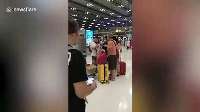 Kindhearted Chinese tourist hands out face masks to fellow travellers at Thai airport