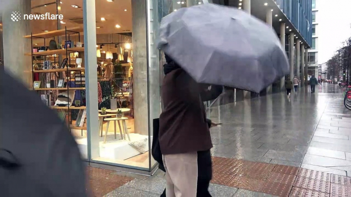 London shoppers struggle with umbrellas during Storm Dennis wind and rain