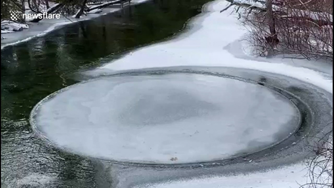 Bizarre phenomenon sees circular ice sheet spinning in Michigan river