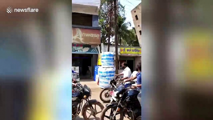 Terrifying footage shows moment two-storey building completely collapses next to busy Indian street