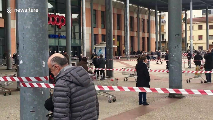 Italian shoppers queue up six foot away from each other during country's coronavirus lockdown