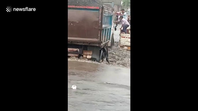 Three people swept from bridge in India during flash floods