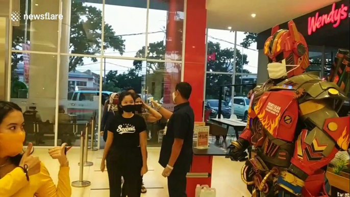 In Indonesia, a masked 'Transformer' educates shoppers on coronavirus