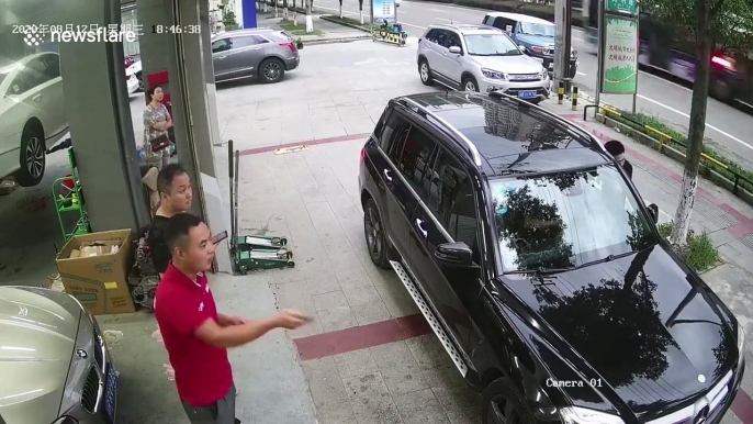 Canopy smashes front windscreen of car after wind blows it over in China