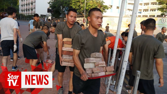 China's PLA soldiers help clean up Hong Kong streets