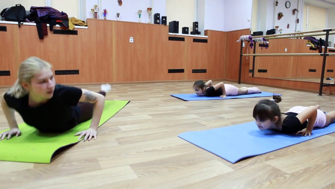 gymnastic body wave on the floor. stretching, flexibility, gymnastics for dancing.