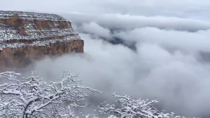 Clouds fill a snow-dusted Grand Canyon