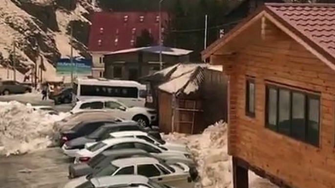 Une avalanche pousse des voitures sur un parking