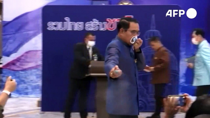 Thai PM sprays alcohol on reporters to escape questions