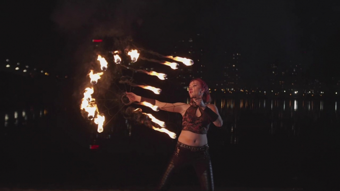 Bold and beautiful woman doing fire stunt energetically