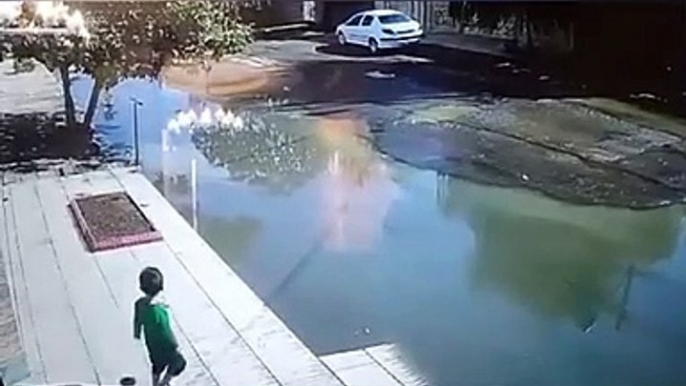 Footage shows a driver rescuing a child from drowning in a giant pothole in the Northwestern city of Parsabad in Ardabil province