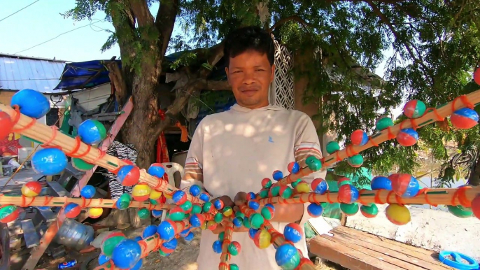 Thai farmer using Ping Pong Bombs to scare away birds in Thailand